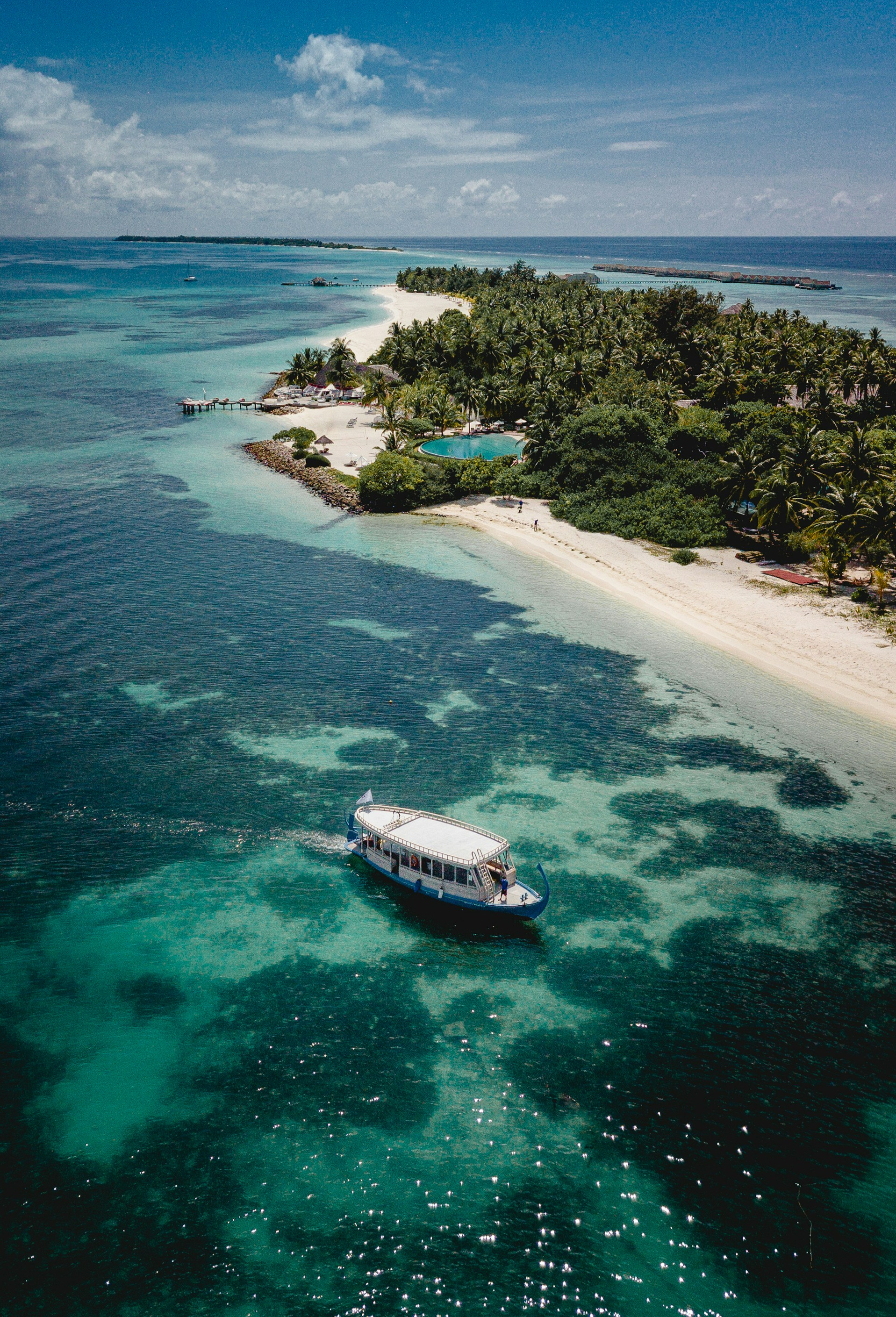 A boat going past a Maldivian island.